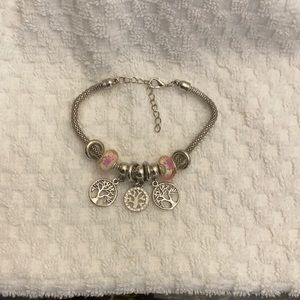 Silver nickel free “Tree of Life” will fit a small or large wrist.